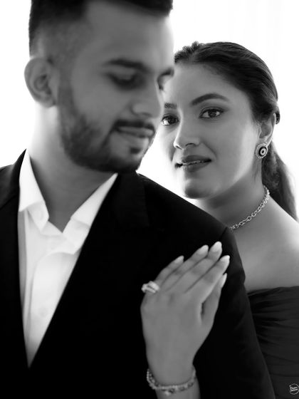 A classic and intimate black and white portrait. The soft focus and close crop create a timeless and romantic feel, drawing all the attention to the couple's gentle interaction.