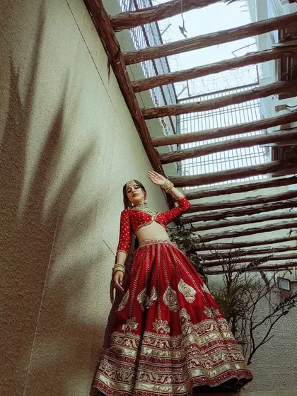 A dynamic pose in a traditional red lehenga. I styled this to show the movement and flow of the luxurious fabric.