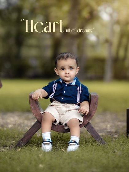 A heart full of dreams. This little boy's first birthday portrait, taken outdoors with rustic props, has a timeless and classic feel.