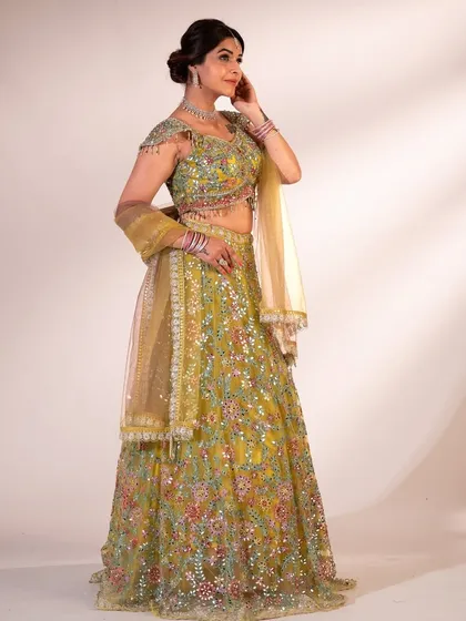 A classic with a twist. This lime green lehenga with intricate floral embroidery is perfect for a daytime wedding or a mehndi function, bringing all the fresh, fun vibes.