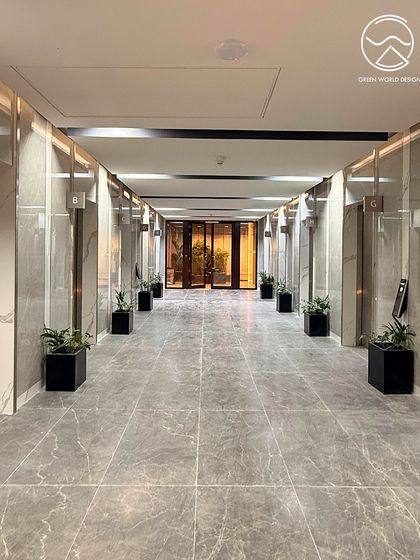 The elevator lobby at The Executive Centre, Hyderabad. The symmetrical placement of simple, elegant planters creates a formal and sophisticated entrance, setting a professional tone from the moment of arrival.