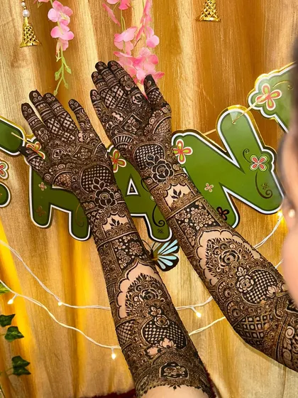 This shot shows the bridal mehendi against a festive background. The intricate design looks stunning and is perfect for a celebration.