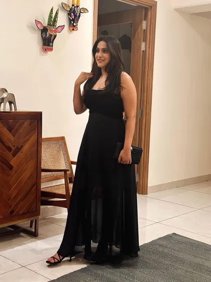 A duplicate image of Sanjana posing in her elegant black gown.
