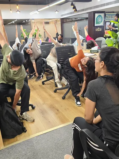To combat the stiffness that comes from hours of sitting, I lead practical chair yoga sessions. These stretches are designed to be done at a desk, targeting common issues like backaches and tight shoulders.