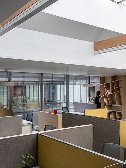On the director's floor, workstations are illuminated by a central skylight, while custom shelving showcases the company's stainless steel products.