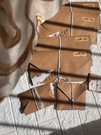 A collection of my vintage letter envelopes, all sealed with a "with love" sticker and tied with string, ready to be sent out.