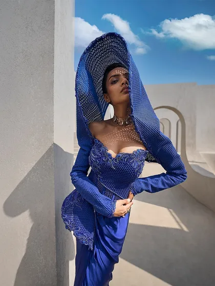 I believe in retelling tradition through structure. Here, an architectural mesh hood in a striking active blue replaces a conventional drape, creating a powerful, contemporary statement for the modern bride.