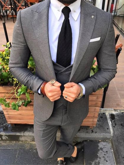 This grey three piece suit shows how texture can elevate a classic color. Paired with a white shirt and a dark tie, it’s a versatile option that works for both the boardroom and special events.