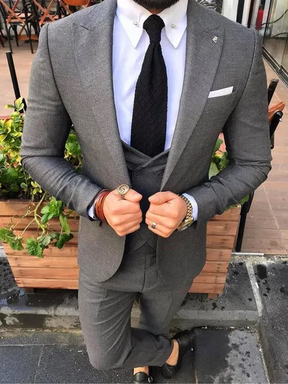 This grey three piece suit shows how texture can elevate a classic color. Paired with a white shirt and a dark tie, it’s a versatile option that works for both the boardroom and special events.