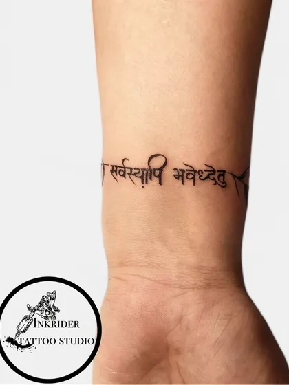 A Sanskrit script tattoo wrapped around the wrist like a bracelet. This is a unique way to wear a meaningful phrase.