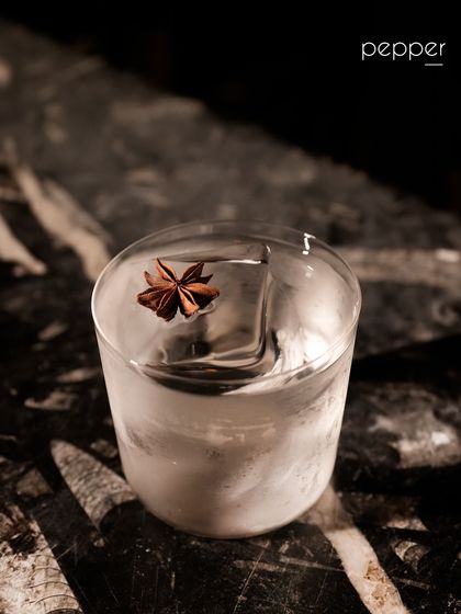 Our Pepper cocktail is a clean and spicy gin-based drink. It features Crafter's London Dry Gin infused with black pepper, balanced with ginger syrup and ginger ale. The star anise garnish adds a fragrant, aromatic finish.
