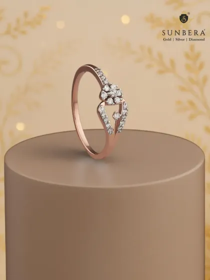 A delicate rose gold ring featuring a floral diamond cluster on a bypass shank. This piece is a beautiful symbol of everyday elegance and makes for a cherished gift.