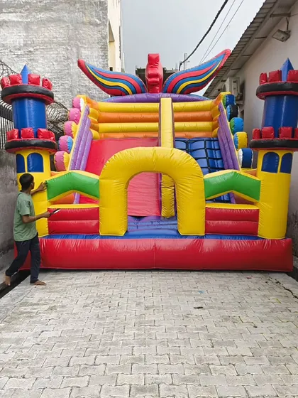 A colorful castle-style bouncy with unique winged details on the towers. This shows our ability to add custom decorative elements to our designs.