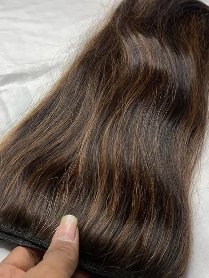 Feeling the quality of the 100% human hair. This 150gm set is soft, has a natural shine, and is ready to be styled.