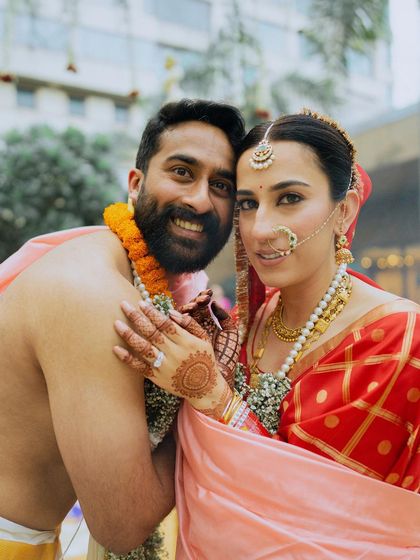 A happy and candid portrait of a South Indian couple, their smiles showing the pure joy of being married.