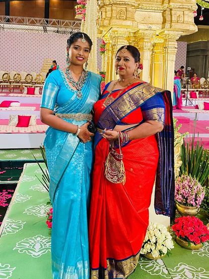 This mother and daughter duo look effortlessly regal. The mother is in our classic red and blue Kanchi silk saree, while the daughter complements her in a vibrant sky blue.