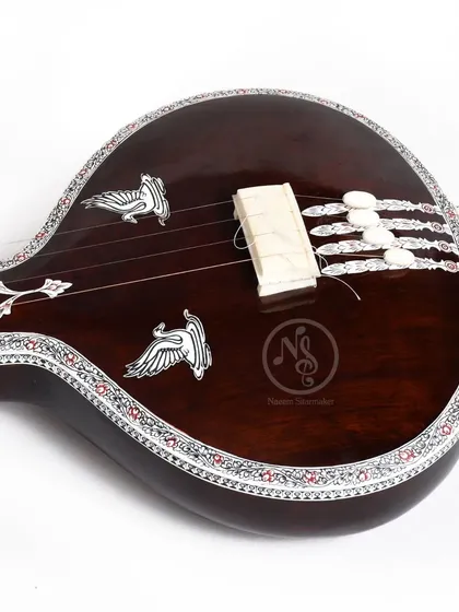 A close-up of the flat wooden tanpuri, showing the fine inlay work and the bird motifs that we often use in our designs.