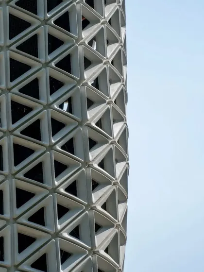 A detailed close-up of VERTO's triangulated facade. The gradient in the openings is a performance-driven feature, with larger apertures at air intake and outlet points. This demonstrates how every aesthetic choice is backed by engineering logic.