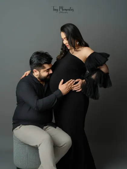 A sweet and classic maternity pose, capturing the partner listening to the baby bump, a moment filled with wonder and love.