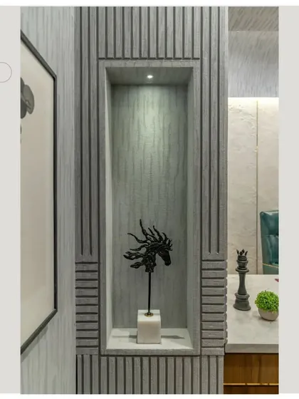A custom niche built into the grooved wall, creating a perfect spot to display art and artifacts within the office.