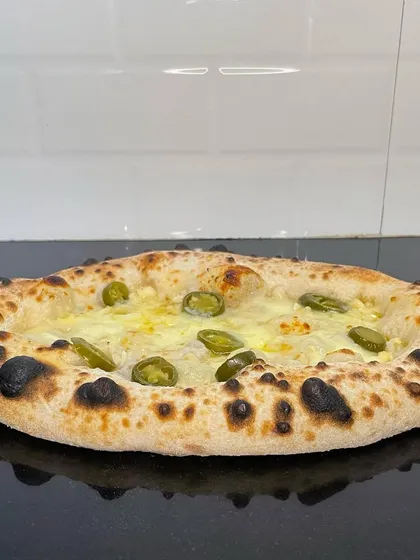 This isn't your average garlic bread. I use my signature high-hydration pizza dough to create a light, chewy, and flavorful base, topped with garlic butter, herbs, and spicy jalapeños for an extra kick. It's the perfect starter for any pizza party.