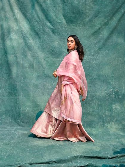 A full-length shot of Akansha Ranjan Kapoor in her pink Raw Mango outfit for 'Dastoor', showing the graceful flow of the ensemble.