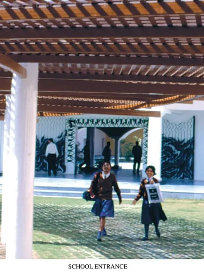 This archival photo shows the entrance to Babrala School, a project from 1996. The shaded pergola and gentle transition from the path to the building demonstrate an early focus on creating welcoming, human-scaled environments.
