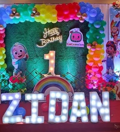 A close-up of the Cocomelon birthday decor we did at Celebration banquet hall. The bright colors, neon sign, and light-up letters create a super fun atmosphere for a kid's party.