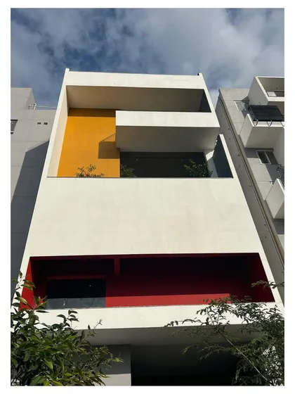 Blocks of bold color, like this yellow and red, are used to punctuate the facade of "The Treehouse," adding visual interest and a sense of identity to different parts of the building.