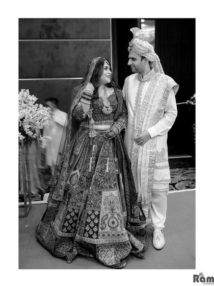 A timeless black and white portrait of the couple, capturing a quiet, loving glance between them.