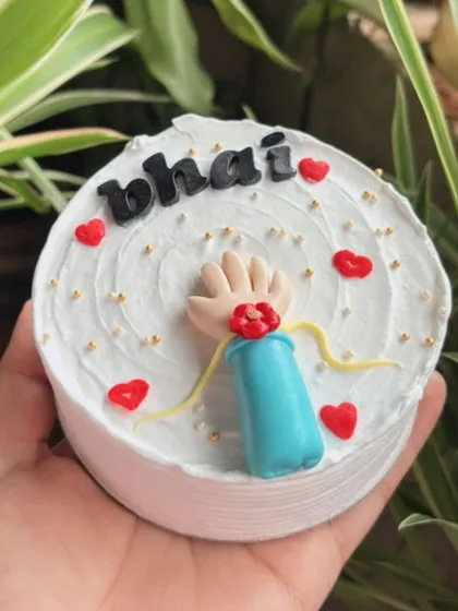A tiny Rakhi cake for 'Bhai', complete with a fondant hand and rakhi.