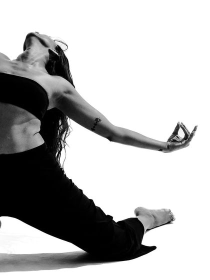 A close-up on a hand mudra during a deep lunge, combining strength with the delicate details of classical dance.