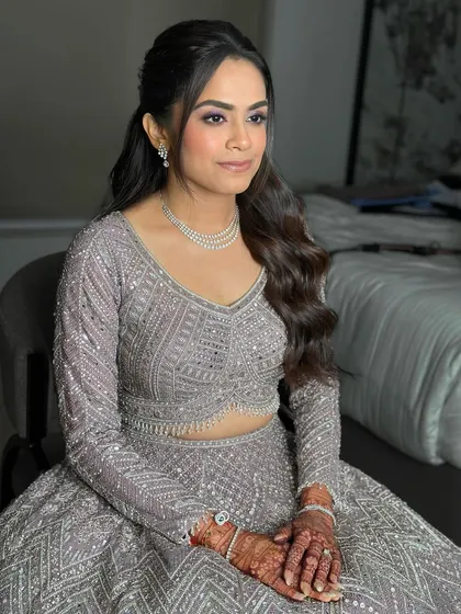A three-quarter view showcasing the sculpted cheekbones and the soft waves of her hair. The entire look is cohesive, from the makeup to the modern hairstyle.
