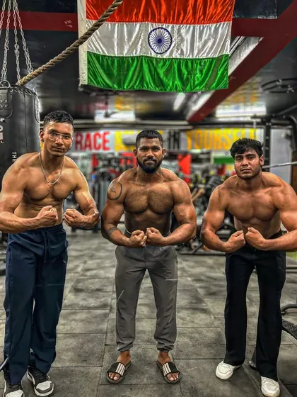 Front double bicep pose with the crew. We stand together, strong and united. This is the power of a supportive community.