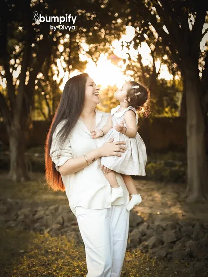 There's nothing like the soft, dreamy glow of the golden hour for an outdoor family photoshoot. This beautiful moment between a mother and her daughter is filled with so much love and natural light.