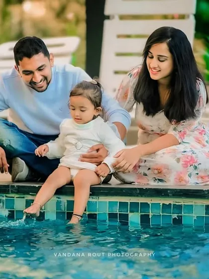 I believe the best family portraits happen when you're just enjoying each other's company. This relaxed, outdoor family photoshoot by the water captures a genuine moment of connection and playfulness between parents and their little one.