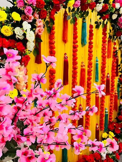 A close-up of the colorful Mehendi ring, with a branch of artificial cherry blossoms in the foreground.
