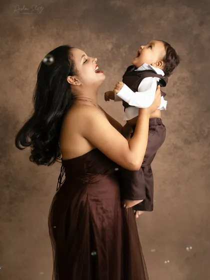 The pure joy of a mother playing with her baby boy. His laughter is infectious, and this photo is full of happiness.