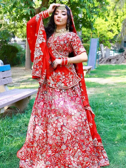 Another pose in the timeless red bridal lehenga, showing its versatility and elegance.