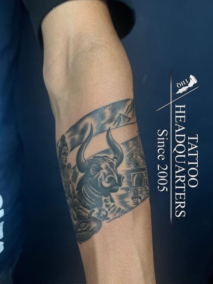 This armband tattoo features a detailed depiction of Lord Shiva with Nandi at the Kedarnath temple, a powerful piece for devotees.