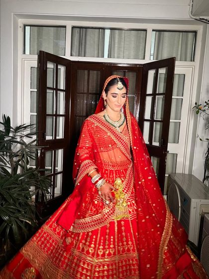 A full-length view of our Italian bride's stunning red lehenga. The entire look is a testament to how traditional Indian bridal wear can be embraced by anyone with grace and beauty.
