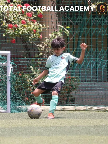 A young player dribbling the ball with confidence and control.
