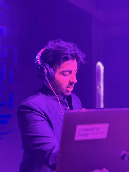 A candid shot of me focused on the mix during a set. The purple lighting adds to the mood of the party as I line up the next track.