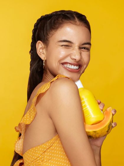 A joyful shot from the yellow-themed campaign, where the model's polka-dot dress perfectly matches the fun, fruity vibe of the product.