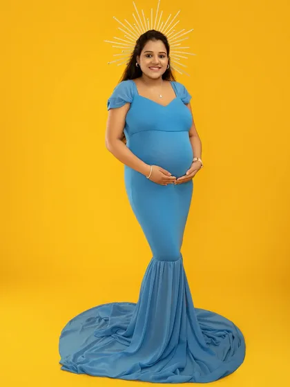 I love playing with color and artistic props to reflect your personality. This shot uses a vibrant yellow backdrop and a celestial halo to create a modern, divine look for this mother-to-be.