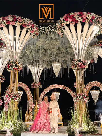 A grand mandap design featuring towering floral structures and cascading chandeliers. This setup is perfect for couples who want a lavish, opulent wedding ceremony that leaves guests in awe.