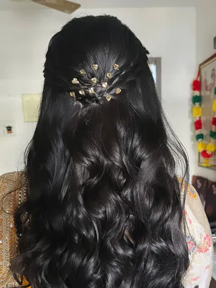 A detailed shot of the back of the hairstyle, showing the delicate hair accessory that completes the look.