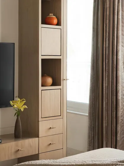 The TV and storage unit in the parents' room, designed with clean lines and a light wood finish to maintain the room's minimal aesthetic.