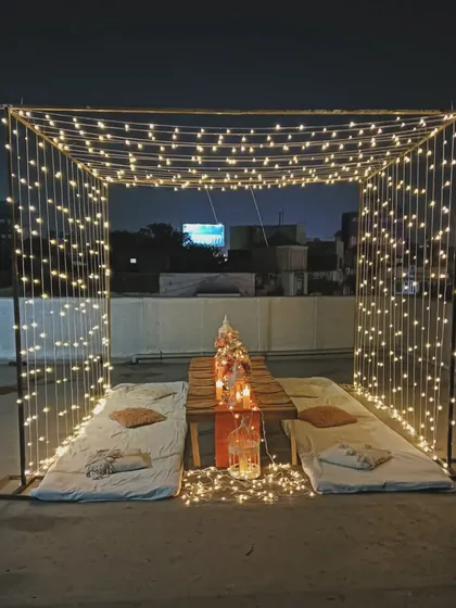 I transformed this rooftop into a romantic paradise with a cube of cascading fairy lights. The low seating and candlelit table make it a perfect spot for an intimate celebration under the stars.