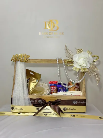 A full view of the decorated Rakhi crate, showing the "Happy Rakhi" tag and branded ribbons.